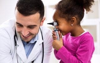 Doctor otologist palying with his patient
